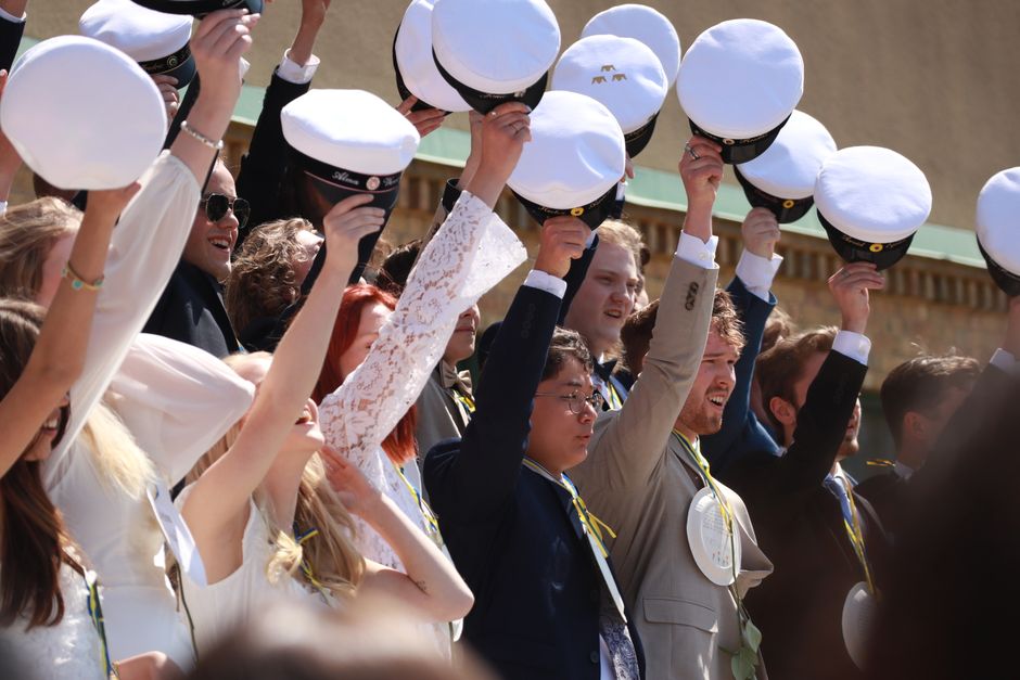 Naval Academy graduates in white uniforms — Commissioning Week charter bus transportation